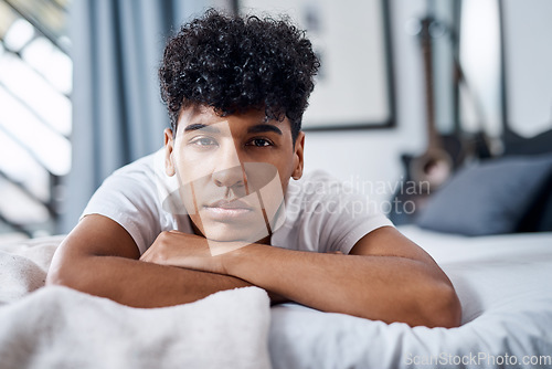 Image of What are my plans Same as every other day. a young man lying on his bed and looking bored.