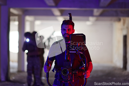 Image of A professional cameraman captures the intense moments as a group of skilled soldiers embarks on a dangerous mission inside an abandoned building, their actions filled with suspense and bravery