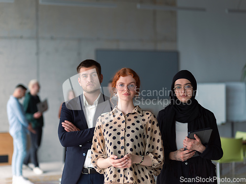 Image of A group of young business entrepreneurs engages in a lively discussion within the office, exemplifying the spirit of teamwork, innovation, and ambition in pursuit of success.