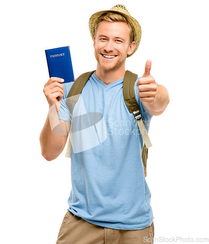 Image of Ive got all I need for my holiday. a young tourist standing in the studio and showing a thumbs up while holding his passport.