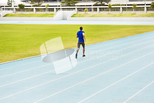 Image of Long distance is his game. Rearview shot of an unrecognizable young male athlete running along the track.