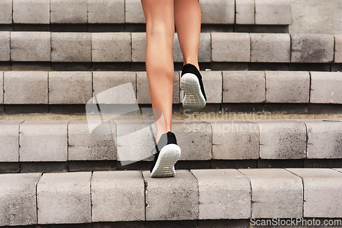 Image of Levelling up. Rearview shot of an unrecognizable young female athlete working out on a flight of stairs at the track.