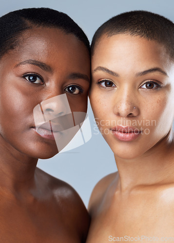 Image of We could have been twins in another life. Portrait of two beautiful young women standing close to each other against a grey background.