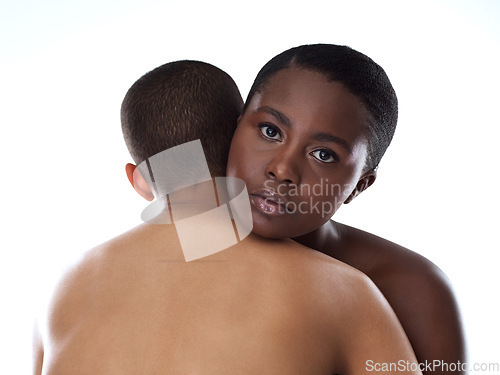 Image of Always be there for whoever needs help. Portrait shot of two beautiful young women holding each other while standing against a grey background.