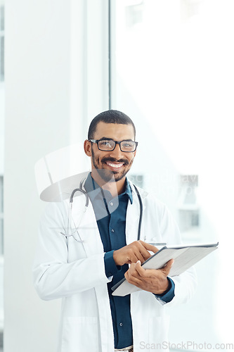 Image of Medical information right at my fingertips. Portrait of a young doctor using a digital tablet in a modern hospital.