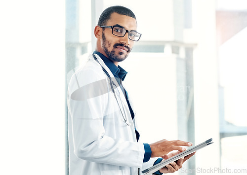 Image of Patient info at the tap of an icon. Portrait of a young doctor using a digital tablet in a modern hospital.