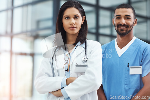 Image of Here to give you the best care possible. Portrait of two confident young doctors working in a modern hospital.