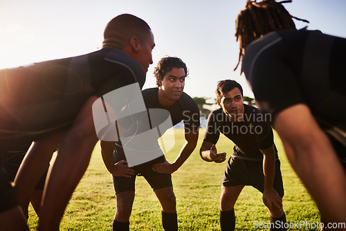 Image of Coming up with a game plan. a diverse group of sportsmen huddled together before playing a game of rugby.