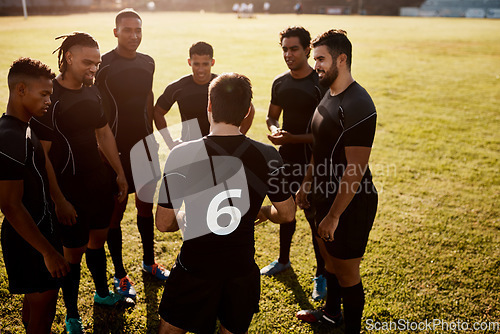 Image of We never run out of things to talk about. a diverse group of sportsmen standing together before playing rugby during the day.