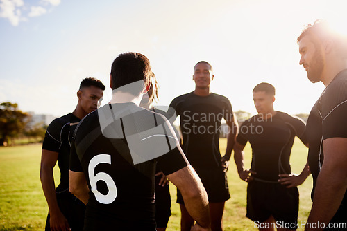 Image of Getting in some last minute motivation. a diverse group of sportsmen standing together before playing rugby during the day.