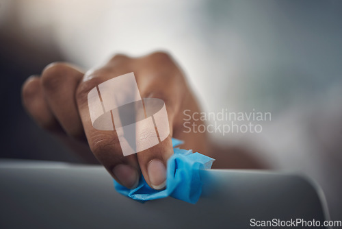 Image of Be sure to continuously disinfect your office equipment. Closeup shot of an unrecognisable businesswoman cleaning a laptop in an office.
