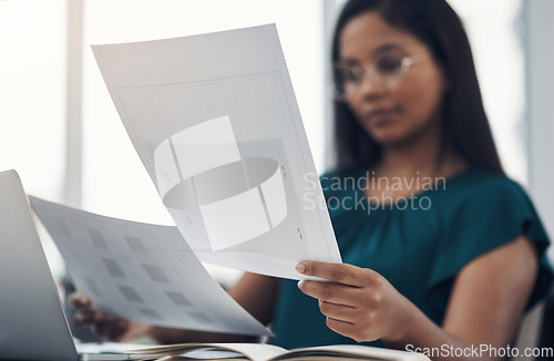 Image of She always has a big plan in the making. Closeup shot of a young businesswoman going through paperwork in an office.