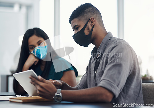 Image of Equipped with all they need to succeed. two businesspeople working together on a digital tablet in an office.