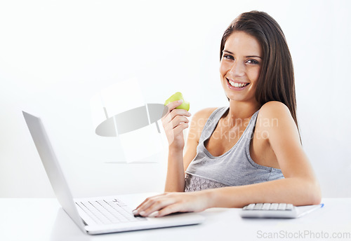 Image of Portrait, laptop and woman nutritionist with apple in studio for wellness, diet or eating plan on white background. Weight loss, face and female health influencer with blog survey, help or menu guide