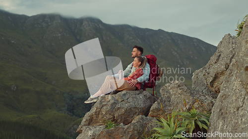 Image of Hiking, mountain and view, couple relax on outdoor adventure travel and peace in nature with romance. Trekking, rock climbing and love, man and woman in natural environment sitting on cliff together.