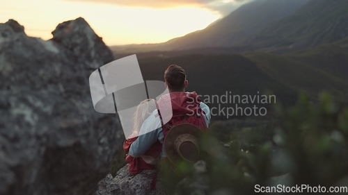 Image of Hiking, mountain and sunrise, couple relax on outdoor adventure and peace in nature with romance from back. Trekking, rock climbing and love, man and woman with sunset horizon view on cliff together.