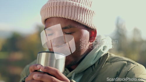 Image of Coffee, camping and relax with black man in nature for adventure, travel and vacation. Morning, freedom and holiday with person drinking tea from mug in outdoors for peace, happy and smile