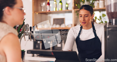 Image of Women, barista or customer order at cafe for service, payment or order on counter at coffee shop. Serving, waitress or employee in small business restaurant helping a girl client at checkout or work