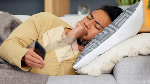 Image of Man, phone and cough on sofa in home living room, texting or communication with email notification. Guy, smartphone and sick with research for health, medicine or watch video on social media in house