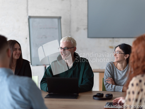 Image of A diverse group of business professionals gathered at a modern office for a productive and inclusive meeting