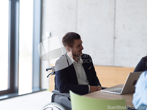 Image of Closeup photo of a disabled person in a modern office at a productive meeting