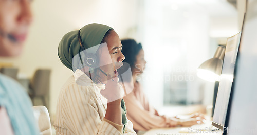 Image of Call center woman, yawn and fatigue at computer, office or tired with team, customer service pr telemarketing. Islamic crm, burnout and overtime for tech support, help desk or consulting in workplace