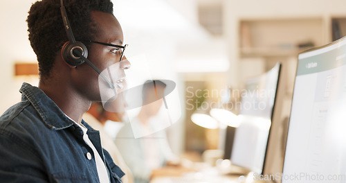 Image of Call center, consulting and computer with black man in office for contact us, communication and customer support. Salesman, help desk and technical support with person in crm agency for telemarketing