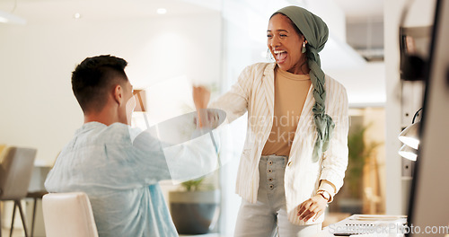 Image of Fist bump, excited and business people in an office for success, celebration or teamwork. Happy, collaboration and a Muslim employee with a man for a thank you, partnership or friends handshake