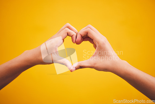 Image of Heart, hands and person in studio with thank you, message or gesture on orange background space. Emoji, frame and human fingers with self love, gratitude and kindness, empathy and hope of healing