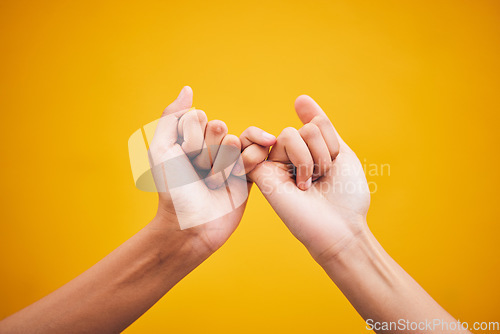 Image of People, hands and pinky promise in studio with trust, help or hope for reconciliation on yellow background. Finger, emoji and deal by friends with secret, gesture and support expression or solidarity