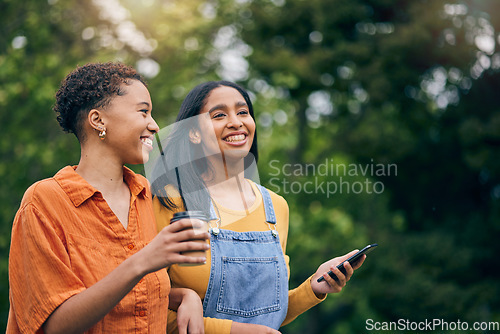 Image of Phone, happy and women in park with coffee together for holiday, bonding and quality time outdoors. Friendship, nature and female people walking in nature for relaxing, conversation and talking