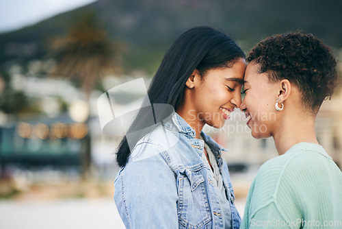 Image of Women, lesbian and couple, hug and pride with gen z youth and romance, forehead touch outdoor. Female people together, gay relationship and lgbt with date, partner and trust with peace and support