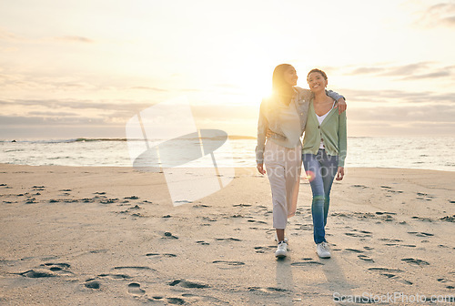 Image of Love, beach and sunset, lesbian couple walking together on sand, sunset holiday adventure or hug on date. Lgbt women, bonding and relax on ocean vacation with romance, pride and happy nature travel.