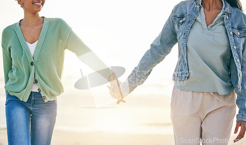 Image of Love, beach and lesbian couple on holding hands on sunset holiday adventure, date or quality time together. Lgbt women, bonding and relax on ocean vacation with romance, pride and happy in nature.