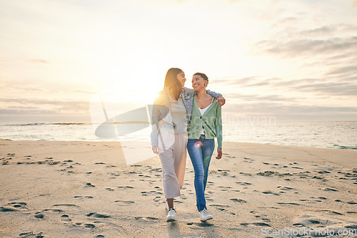 Image of Love, beach and sunset, lesbian couple walking together on sand mockup, sunset holiday and hug on date. Lgbt women, bonding and relax on ocean vacation with romance, pride and happy nature travel.