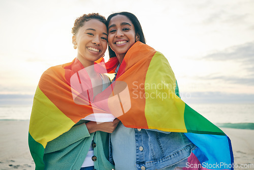 Image of Rainbow flag, gay couple or women with love outdoor for happiness, rights and pride at sunset. Portrait of LGBTQ or lesbian friends or people in at beach for freedom, date and hug with happy partner