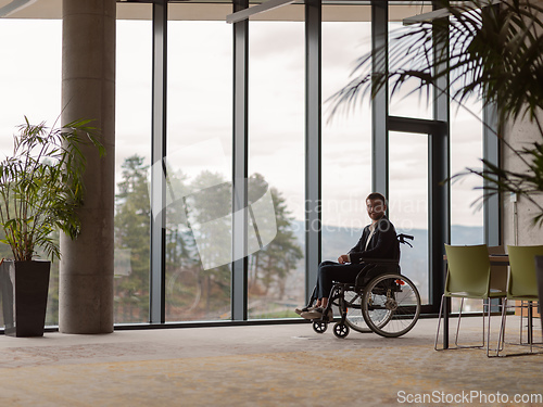 Image of Businessman in a wheelchair in a modern office lonely after a busy day