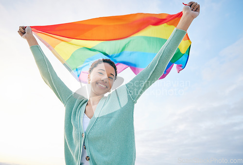 Image of Woman, outdoor and rainbow pride flag in portrait with smile, wind and wave for lgbtq, inclusion and equality. African girl, fabric or cloth for human rights, lesbian sexuality and happy on vacation