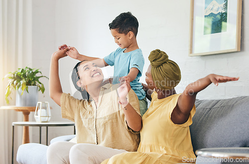 Image of Gay family, lesbian couple and boy child on a sofa with airplane, game and fun in their home together. Love, lgbt and women mother in a living room with kid and piggyback, bond and playing in a house