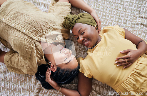 Image of LGBT, love and couple relax, happiness and smile for home bonding, support and enjoy quality time together. Romance, top view floor and gay people, queer partner or lesbian women connect in apartment