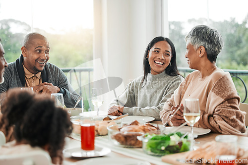 Image of Smile, food and relax with big family in dining room for lunch, happy and holiday celebration. Thanksgiving, party and dinner with people laughing at table in home for nutrition, happiness and love