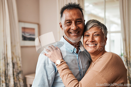 Image of Portrait, happy and senior couple in home living room for bonding together. Face, elderly man and Indian woman in lounge to smile for quality time, hug for support and embrace for love in retirement