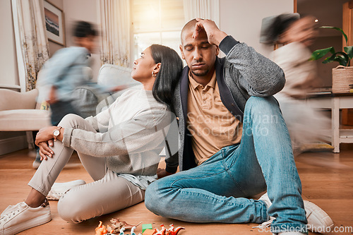 Image of Family, adhd children and parents headache, stress and anxiety for autism management, energy fatigue or home noise. Tired mother and father on floor with chaos and hyper or fast, excited kids running