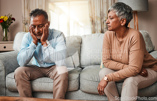 Image of Angry, senior couple and fight on sofa, divorce and conflict with a breakup, depression and stress. Sad, old woman and elderly man with mental health, cheating and separation with crisis at home