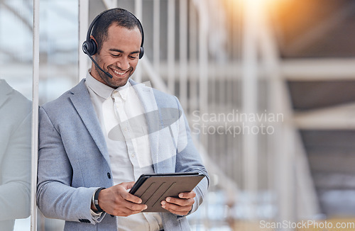 Image of Call center, tablet and happy man typing in office for telemarketing, website help or crm in office. Support, contact us or customer service business consultant planning schedule or consulting online