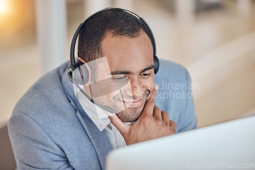 Image of Call center, thinking and happy man at computer for telemarketing, support and crm in office. Contact us, reading and customer service professional, sales agent or consultant at help desk to focus