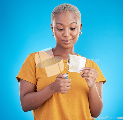 Image of Woman, burning money and euro bills on fire, flame or financial crisis on studio, blue background and college student. Inflation, increase and banknote of dollar or African customer spending cash