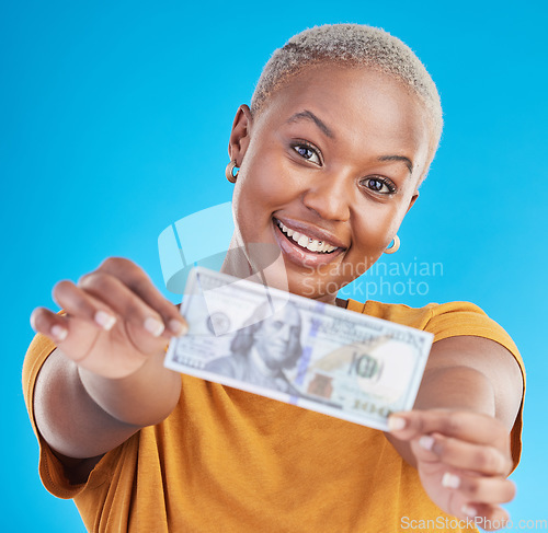 Image of Black woman, dollar and finance, portrait and happy with prize, loan and cash on blue background. Money, cashback and lottery win with payment, financial freedom and note with bonus in studio