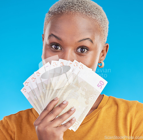 Image of Cash, winner and woman cover face on blue, studio background for winning, money fan or financial loan. Lottery, bank and young african person with bonus, budget secret and finance profit in portrait