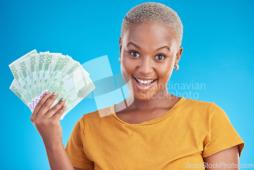 Image of Black woman, money fan and finance, portrait and happy with prize, loan and dollars isolated on blue background. Cash, cashback and lottery win with payment, financial freedom and bills in studio